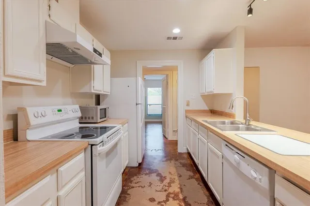a kitchen with a stove and a sink
