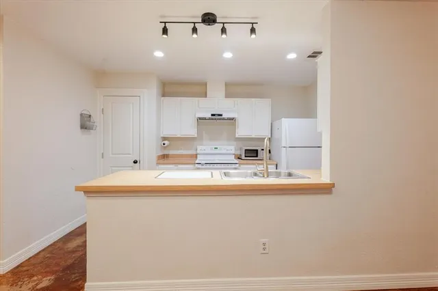 a view of a kitchen with marble kitchen and stainless steel appliances