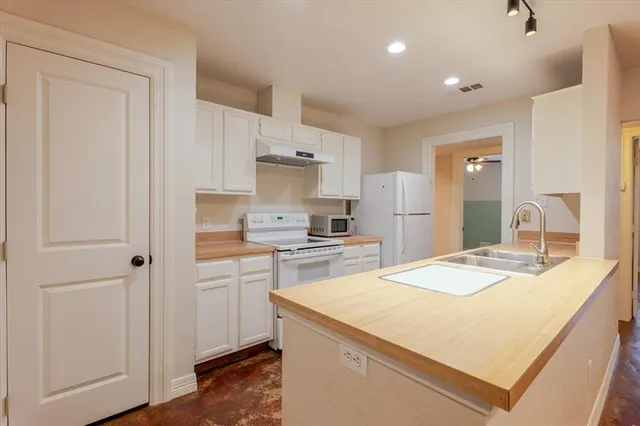 a kitchen with a stove a sink and a refrigerator