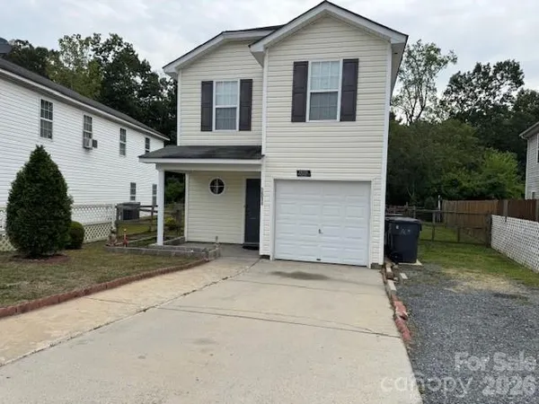 a view of a house with a yard and garage