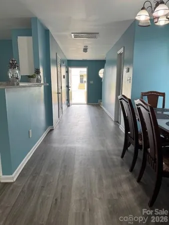 a view of a kitchen with furniture and wooden floor