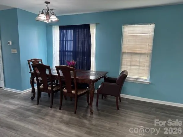 a view of a dining room with furniture wooden floor and chandelier