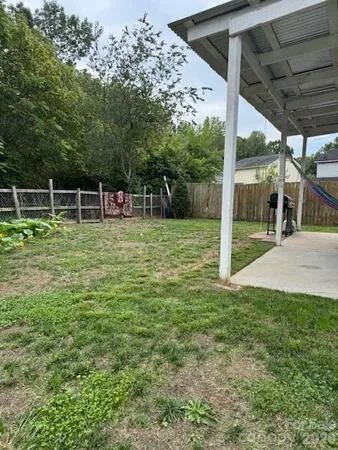 a backyard of a house with table and chairs