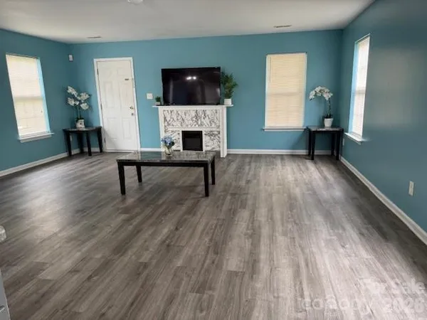 a view of livingroom with furniture fireplace and window