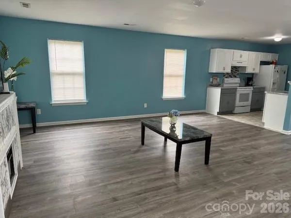 a living room with furniture wooden floor and a table