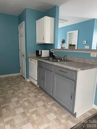 a bathroom with a sink vanity and mirror
