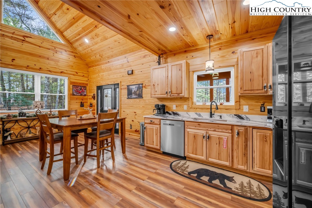 2533 Buck Mountain Road Purlear, NC 28665 - Photo 14 of 40 a kitchen with stainless steel appliances granite countertop a stove a sink dishwasher and cabinets with wooden floor