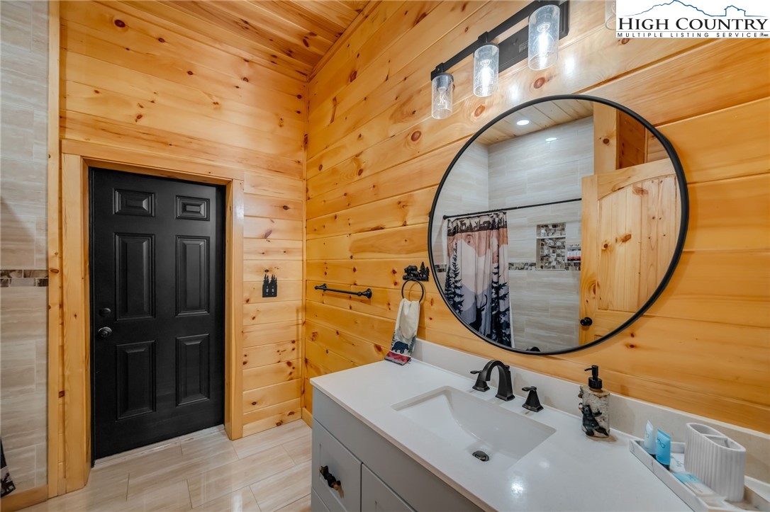 2533 Buck Mountain Road Purlear, NC 28665 - Photo 16 of 40 a bathroom with a sink a mirror and a shower