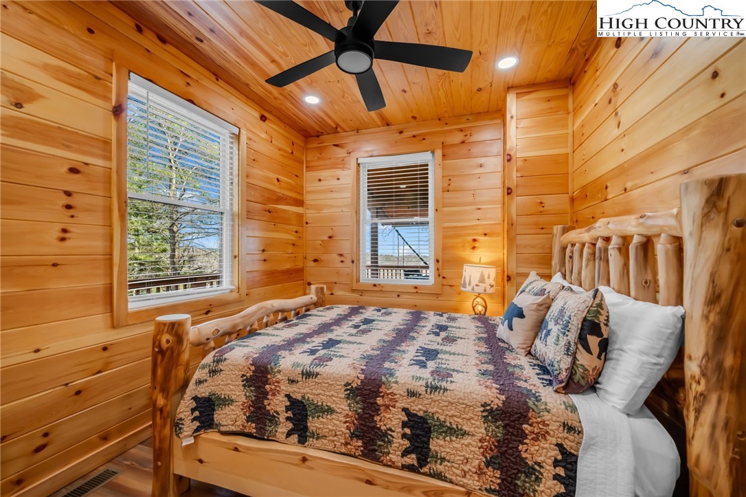 2533 Buck Mountain Road Purlear, NC 28665 - Photo 27 of 40 a bedroom with a bed and wooden floor