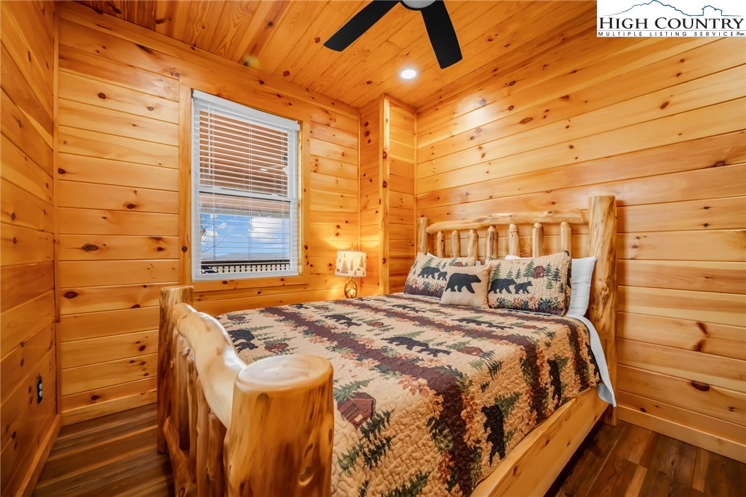 2533 Buck Mountain Road Purlear, NC 28665 - Photo 29 of 40 a bed sitting in a bedroom next to a window