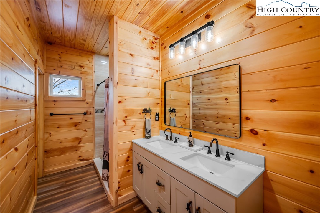 2533 Buck Mountain Road Purlear, NC 28665 - Photo 32 of 40 a bathroom with a sink and a mirror