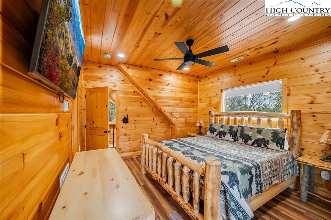 2533 Buck Mountain Road Purlear, NC 28665 - Photo 35 of 40 a bedroom with a bed and wooden floor