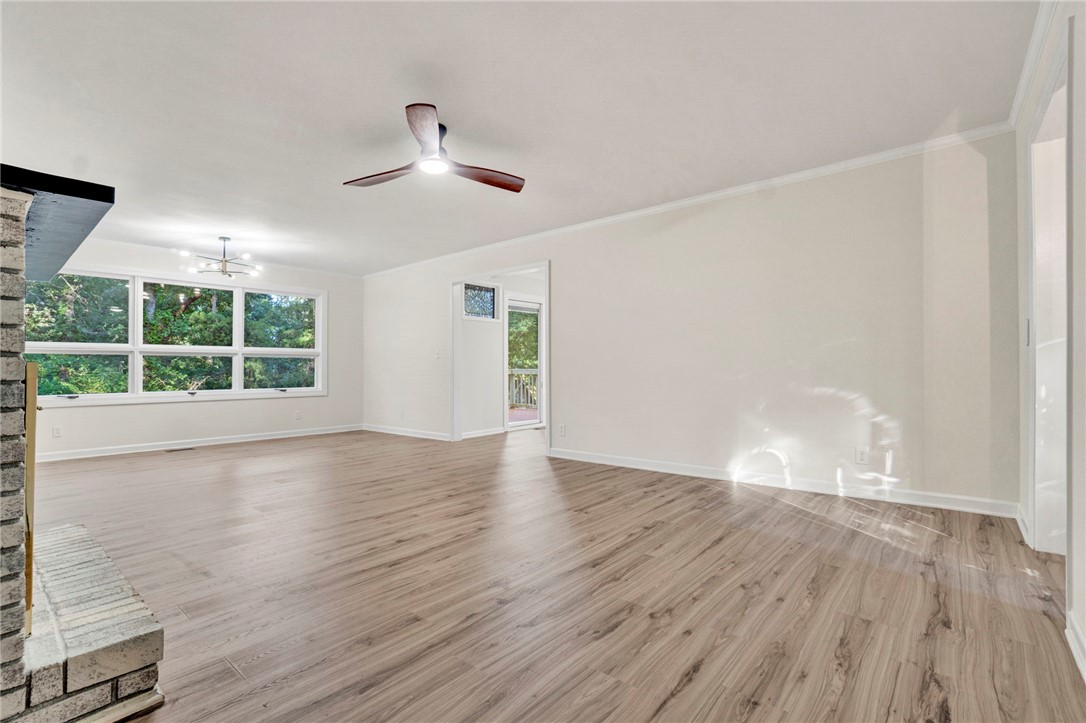 237 Earle Road Central, SC 29630 - Photo 8 of 24 A spacious living area with resilient wood flooring and a refreshing ceiling fan.
