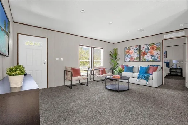 a living room with furniture and a large window