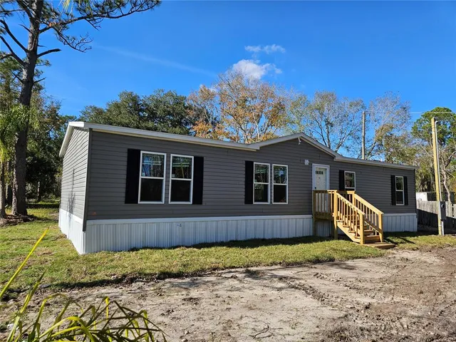 a front view of a house with garden and patio