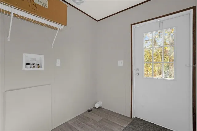 a view of an entryway with wooden floor