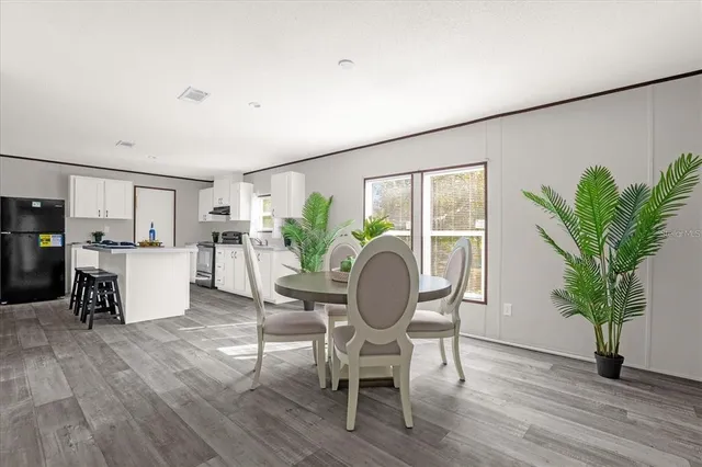 a living room with furniture and a kitchen area