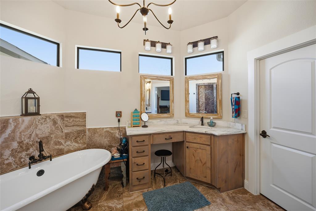 3105 Pastor Street Dallas, TX 75212 - Photo 18 of 28 Full bath with vanity, a chandelier, a soaking tub, and tile walls