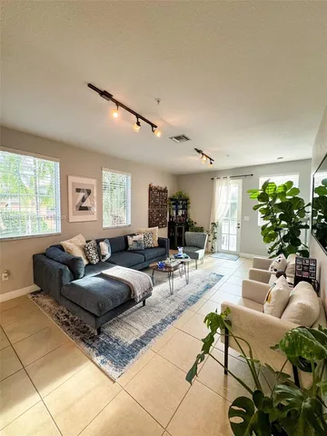 a living room with furniture and a large window