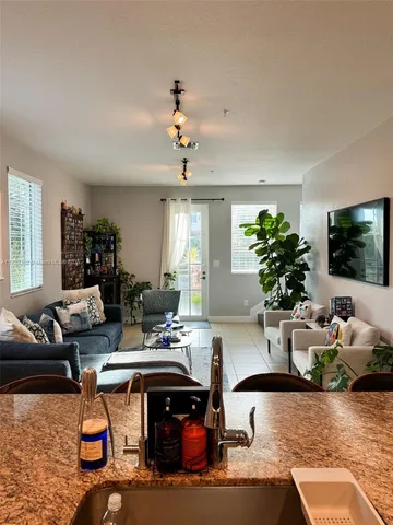 a living room with furniture flowerpot and a window