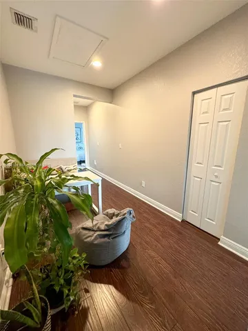a view of a hallway with wooden shelves