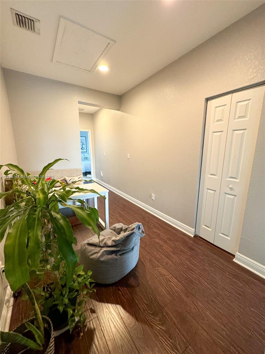 1006 Southwest 147th Avenue, Unit 10601 Pembroke Pines, FL 33027 - Photo 21 of 38 a room with wooden floor