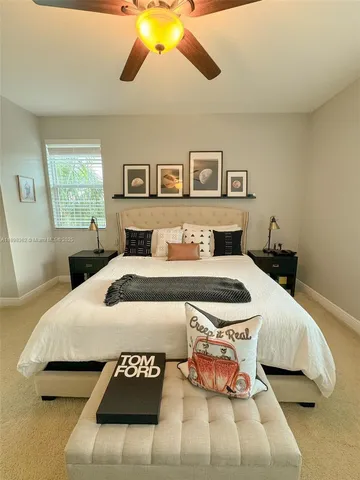 a bedroom with a bed mirror and window