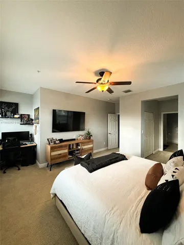 a bedroom with furniture and a flat screen tv