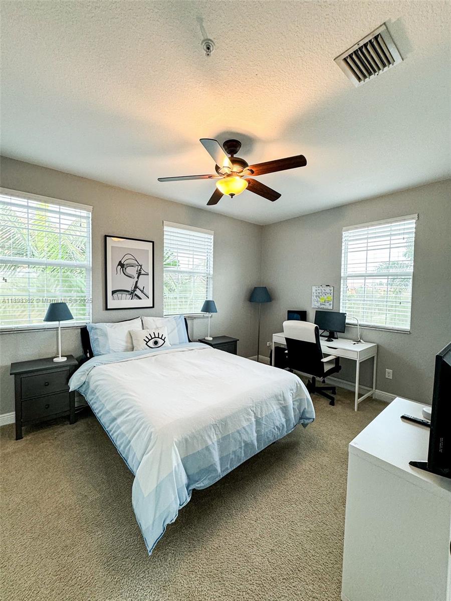 1006 Southwest 147th Avenue, Unit 10601 Pembroke Pines, FL 33027 - Photo 28 of 38 a bedroom with a bed and a large window