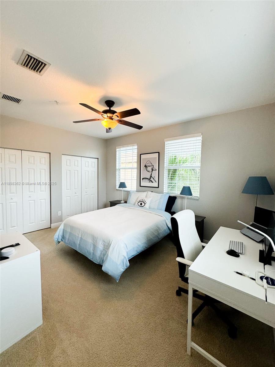 1006 Southwest 147th Avenue, Unit 10601 Pembroke Pines, FL 33027 - Photo 29 of 38 a bedroom with a bed and large windows