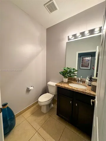 a bathroom with a granite countertop sink mirror and a bathtub