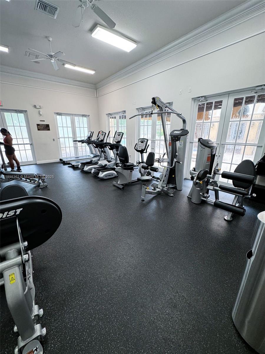 1006 Southwest 147th Avenue, Unit 10601 Pembroke Pines, FL 33027 - Photo 37 of 38 a view of a room with gym equipment