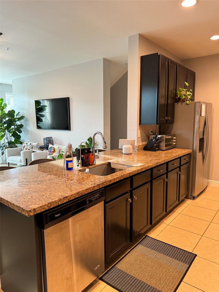 1006 Southwest 147th Avenue, Unit 10601 Pembroke Pines, FL 33027 - Photo 6 of 38 a bathroom with a sink double vanity granite and a mirror