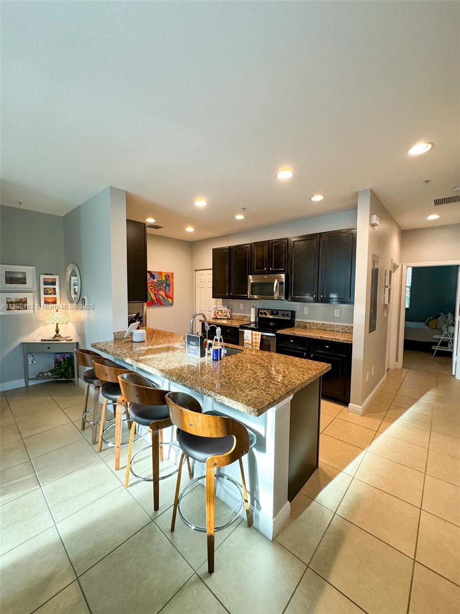 1006 Southwest 147th Avenue, Unit 10601 Pembroke Pines, FL 33027 - Photo 7 of 38 a kitchen with stainless steel appliances lots of counter top space