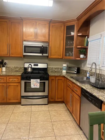 a kitchen with a stove top oven and sink