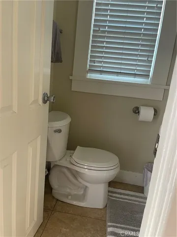 a bathroom with a toilet and a window