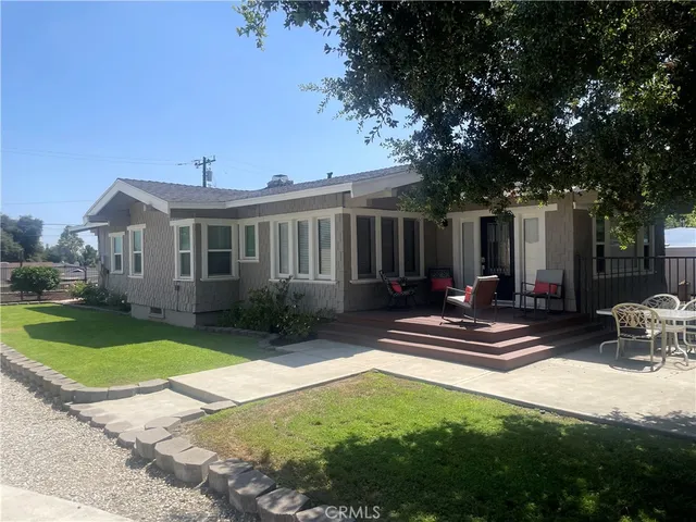 a view of a patio with table and chairs with wooden fence and plants