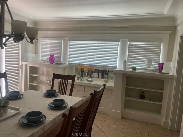 a kitchen with a stove a table and chairs