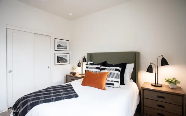 a bedroom with a bed and a potted plant