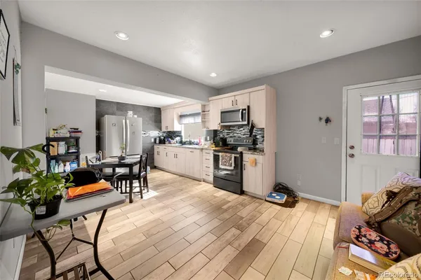 a living room with stainless steel appliances kitchen island granite countertop furniture and a kitchen view