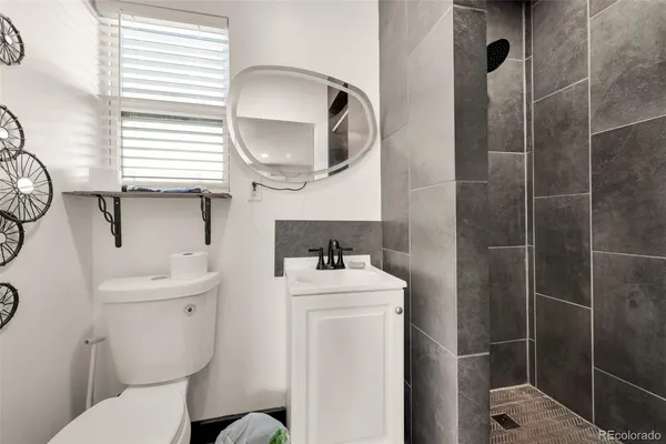 a bathroom with a sink toilet and a mirror