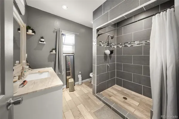 a bathroom with a shower sink and mirror