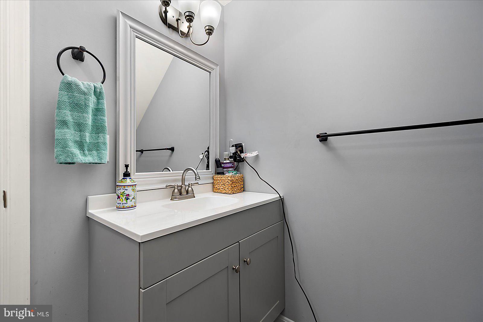 411 East Walnut Street Hebron, MD 21830 - Photo 27 of 54 a bathroom with a sink a mirror and vanity