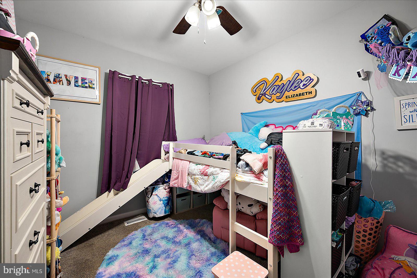 411 East Walnut Street Hebron, MD 21830 - Photo 29 of 54 a bedroom with a bed and a chandelier