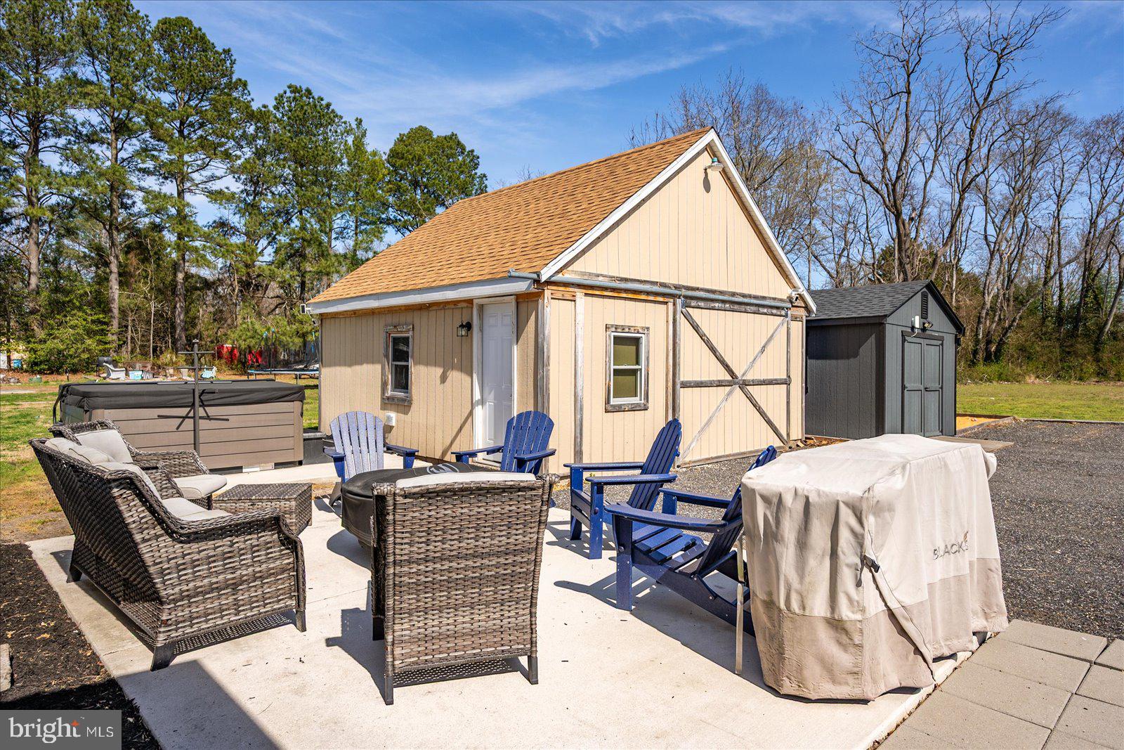 411 East Walnut Street Hebron, MD 21830 - Photo 46 of 54 a view of a patio with couches and table and chairs and wooden fence