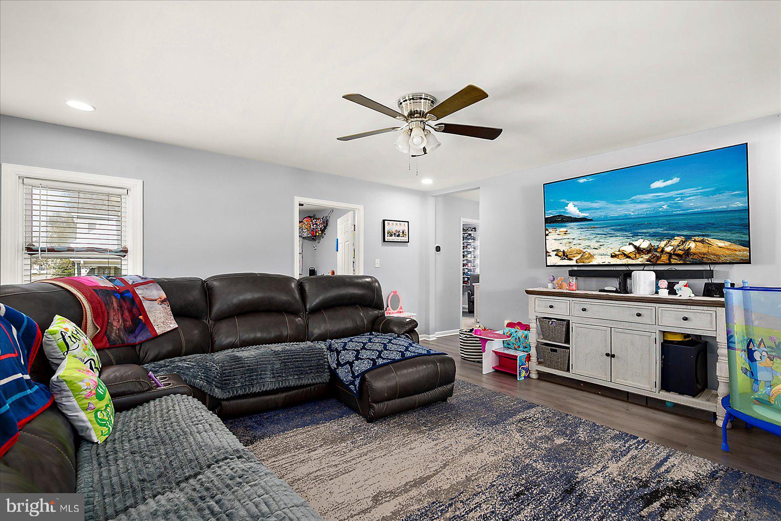411 East Walnut Street Hebron, MD 21830 - Photo 5 of 54 a living room with furniture a flat screen tv and kitchen view