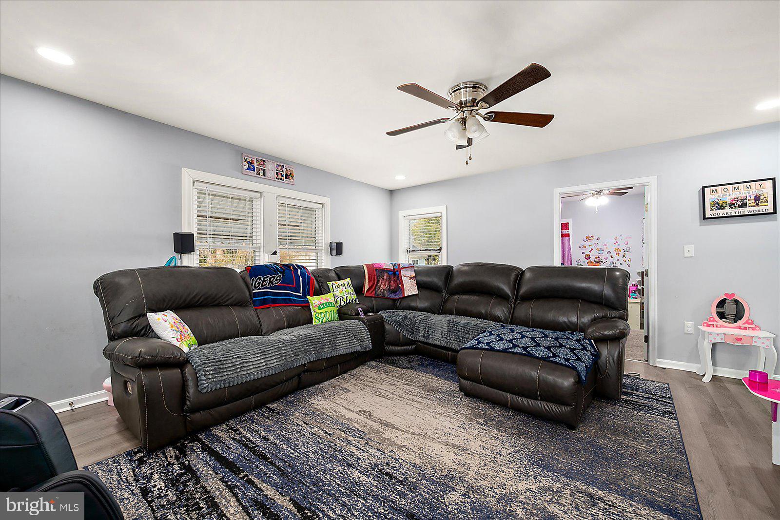 411 East Walnut Street Hebron, MD 21830 - Photo 6 of 54 a living room with furniture a ceiling fan and a rug