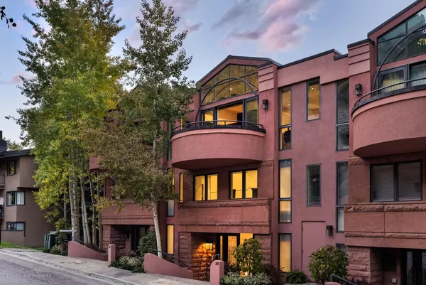 a front view of a building with a yard