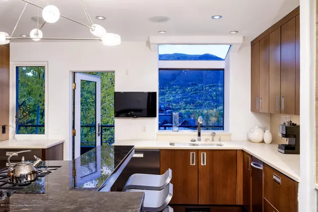 a kitchen with a sink cabinets and window