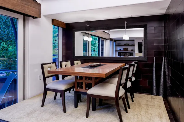 a dining room with furniture and window